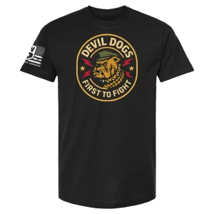 Black unisex t-shirt with circular Devil Dogs badge: snarling bulldog head, lightning bolts, and text “First to Fight”