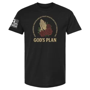 Black t-shirt with praying hands and red roses graphic, circular scripture text “God destroys your plans so that your plans don’t destroy you,” and “GOD’S PLAN” beneath
