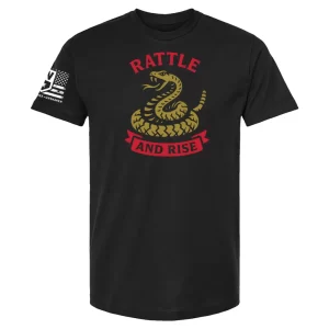 Black unisex t-shirt with a coiled rattlesnake graphic and red “RATTLE” text above, plus a red banner reading “AND RISE”