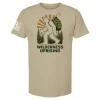 Sand t-shirt with Wilderness Uprising backpacking Bigfoot graphic, forest backdrop, sunburst, and text “Wilderness Uprising”
